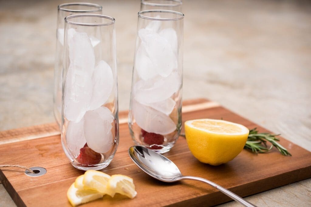 ice filled glasses with raspberry