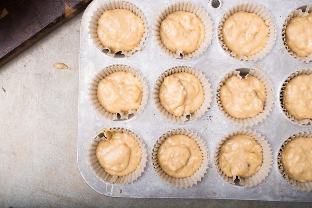 pour banana muffin batter into cups